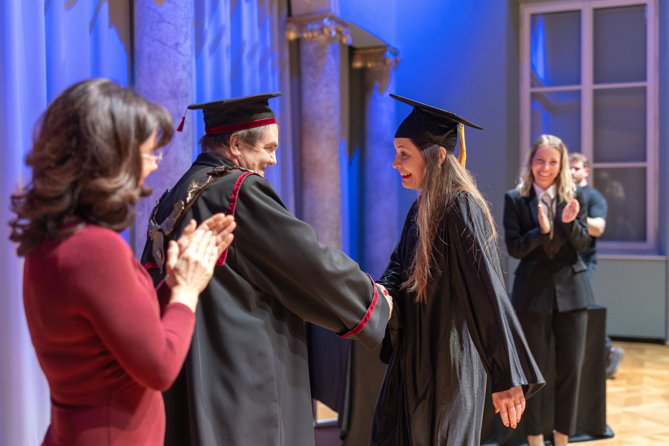 Alma Čaušević Klemenčič shaking hands with dean Tomaž Turk